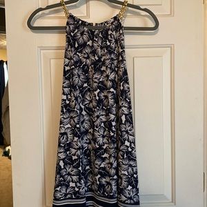 Michael Kors sleeveless floral print top with gold chain detail.